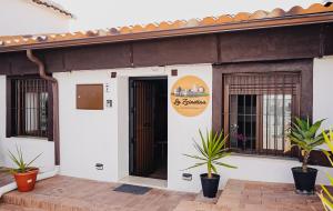a building with a door and plants in front of it at Casa Rural La Zzinetina con Jacuzzi in Constantina