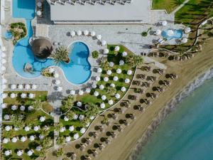 an aerial view of a resort with a pool at Golden Bay Beach Hotel in Larnaca