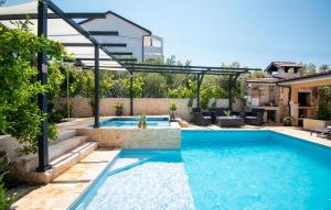 a swimming pool in the backyard of a house at Beautiful Home In Brodarica With Wifi in Brodarica