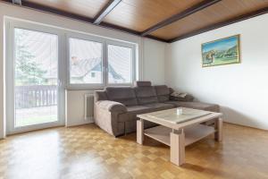 a living room with a couch and a table at Apartmaji Seljak in Preddvor