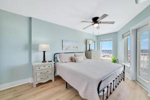 a bedroom with a bed and a ceiling fan at Boardwalk Condos in Gulf Shores