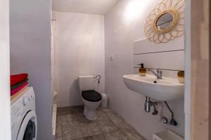 a white bathroom with a sink and a toilet at Chata Mazurska in Orzysz +29 photos