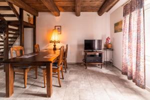 a dining room with a wooden table and chairs at Chata Mazurska in Orzysz