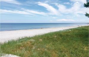 a beach with people on the sand and the ocean at Lien in Snogebæk