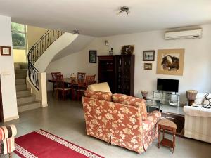 a living room with a couch and a table at Two bedroom villa with private swimming pool and garden in Almadies in Dakar