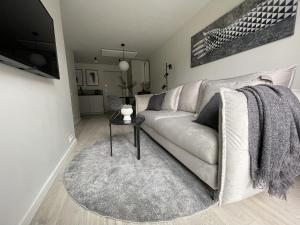 a living room with a couch and a table at Malūno vilos in Palanga