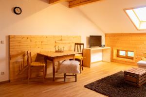 a dining room with a wooden table and chairs at Stadlerhof in Frasdorf