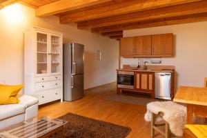 a kitchen with stainless steel appliances and wooden cabinets at Stadlerhof in Frasdorf