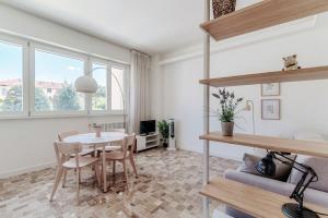 a dining room with a table and chairs in a room at Ria Apartment by Quokka 360 - in the centre of Como in Como