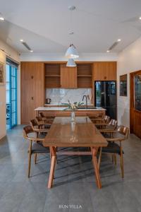 a kitchen and dining room with a table and chairs at Spacious 6BR Villa Near Beach in Ha Long