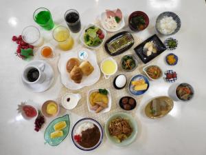 a table topped with plates of food and drinks at Terminal Hotel Matsuyama in Matsuyama