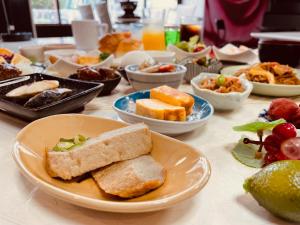 a table with plates of food and bowls of food at Terminal Hotel Matsuyama in Matsuyama