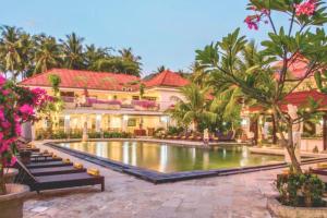 a resort with a pool in front of a building at Celosia 1 BR Superior Room AN23 in Mangsit