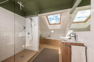 a bathroom with a shower and a sink at Ferienwohnungen am Dorfbach in Bezau