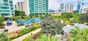 a park in the middle of a city with buildings at Charme by Kozystay - Setiabudi in Jakarta
