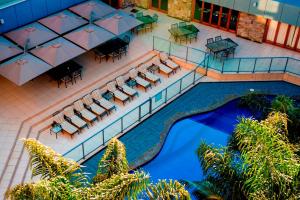 an overhead view of a pool with chairs and tables at Emerald Hotel in Gisborne