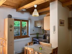a kitchen with a table with chairs and a window at Ferencesek 44 Apartman in Pécs