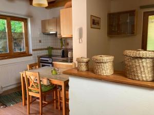 a kitchen with a table and chairs and a counter top at Ferencesek 44 Apartman in Pécs