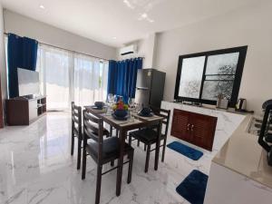 a dining room with a table and chairs in a room at Waan Samui Pool Villa in Taling Ngam Beach