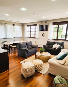 a living room with couches and a dining room at Casa Donato in Narón