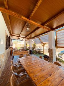 a large wooden table and chairs on a patio at CASA RURAL PRIVADA El ASIENTO LOS GEMELOS in Pruna +55 photos