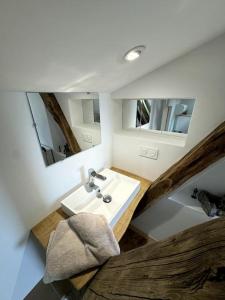 a bathroom with a sink and two mirrors at L'Épicerie de Bezenac in Bézenac
