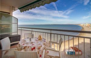 a table on a balcony with a view of the beach at 2 Bedroom Cozy Apartment In Santa Pola in Santa Pola +19 photos
