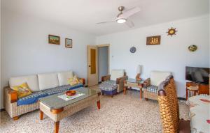 a living room with a couch and chairs and a tv at 2 Bedroom Cozy Apartment In Santa Pola in Santa Pola