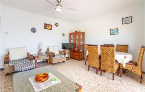 a living room with chairs and a table and a tv at 2 Bedroom Cozy Apartment In Santa Pola in Santa Pola
