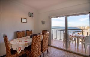 a dining room with a table and a view of the ocean at 2 Bedroom Cozy Apartment In Santa Pola in Santa Pola