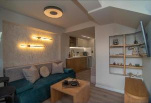 a living room with a couch and a table at ALIVIO Lux Residences in Nafplio