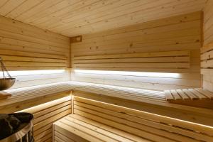 a wooden sauna with a window in it at House for 20 people with a private SPA and bar Koma House in Sidzina