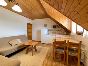 a room with a bed and a table and a kitchen at Apartmány v Müllerovom dome in Banská Štiavnica +33 photos