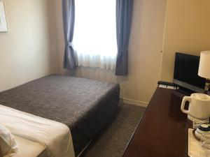 Postel nebo postele na pokoji v ubytování Asakusa Central Hotel
