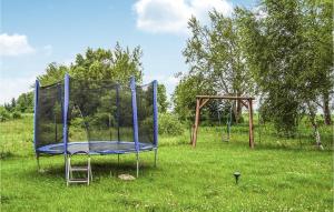an empty trampoline in a field of grass at 2 Bedroom Lovely Home In Osieki in Osieki +8 photos
