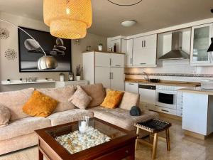 a living room with a couch and a kitchen at Apartamento centro Porto do Son in Porto do Son