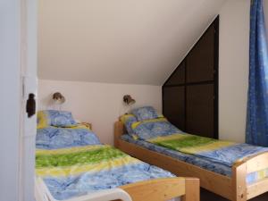 a bedroom with two beds and a cabinet at Petőfi 4 in Balatonmáriafürdő