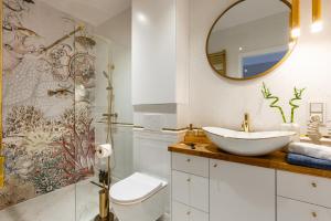 a bathroom with a sink and a mirror at Rooftop Wawel view with jacuzzi l luxury apartment in Kraków
