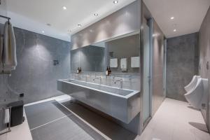 a bathroom with a large sink and a toilet at Nidhra Boutique Hotel Bangkok Sukhumvit in Bangkok +37 photos