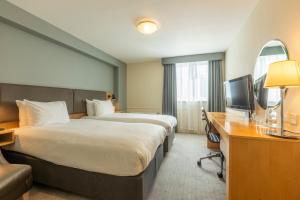 a hotel room with a bed and a desk and a television at Holiday Inn Brentwood, an IHG Hotel in Brentwood