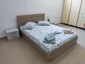 a bedroom with a bed with two towels on it at Mama Marina apartement near to the airport 2 in Antimácheia