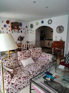 a living room with a couch and a table at Dúplex Buganvillas in Los Amarguillos +12 photos