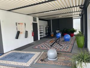 a covered patio with a room with plants at Hotel La Perla in Riva del Garda