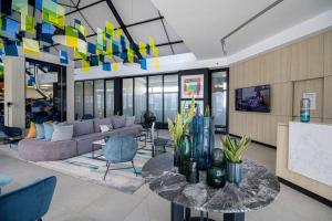 a living room with a couch and a table at Bella Mare 13 on Boardwalk in Gqeberha