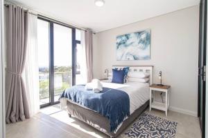 a bedroom with a bed and a large window at Bella Mare 13 on Boardwalk in Gqeberha +45 photos