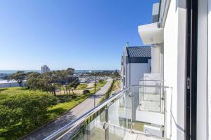 a balcony of a building with a view of a street at Bella Mare 13 on Boardwalk in Gqeberha