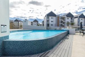 a swimming pool on the side of a building at Bella Mare 13 on Boardwalk in Gqeberha