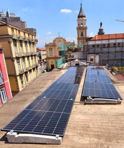 a group of solar panels on the roof of a building at AL centro in Frattamaggiore