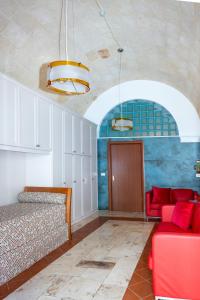 a room with a bed and a couch and a table at Il Tulipano Rosso in Oria +16 photos