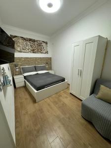 a bedroom with a bed and a couch in it at Il Sogno di Sperlonga in Sperlonga +11 photos
